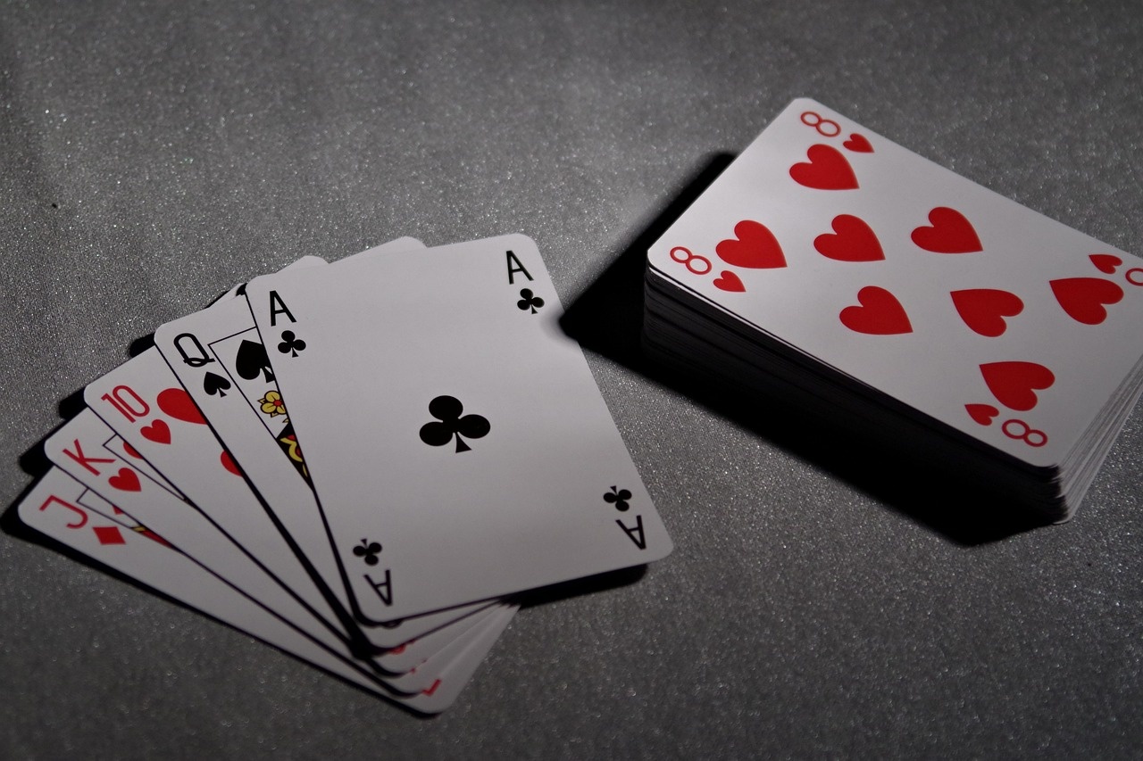 Moody close-up of playing cards on a dark table