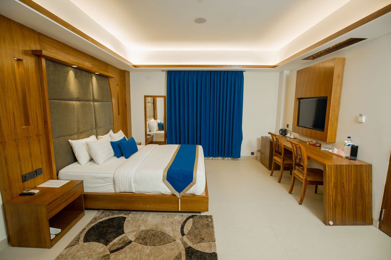 Executive hotel suite with wood finishes and blue accents